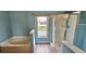 Bright bathroom featuring a soaking tub, walk-in shower, and a window with a view at 3222 Reserve Ct, Orlando, FL 32825