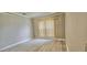 An empty bedroom features wood-look floors, neutral walls and a window with vertical blinds at 3222 Reserve Ct, Orlando, FL 32825