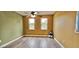 Spacious bedroom with two windows, ceiling fan, and wood-look floors at 3222 Reserve Ct, Orlando, FL 32825