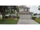 Inviting two-story home featuring a two-car garage and well-maintained front lawn landscaping at 3222 Reserve Ct, Orlando, FL 32825