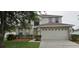 Inviting two-story home featuring a two-car garage and well-maintained front lawn landscaping at 3222 Reserve Ct, Orlando, FL 32825