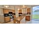 A kitchen features oak cabinets, an island and stainless steel appliances at 3222 Reserve Ct, Orlando, FL 32825