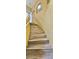 A long staircase features wood-look steps and bright, yellow walls at 3222 Reserve Ct, Orlando, FL 32825