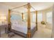 Ornate main bedroom with a four poster bed and natural light at 3429 Regal Crest Dr, Longwood, FL 32779