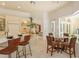 Bright kitchen with breakfast bar, cream cabinetry and adjacent breakfast nook with a glass table at 3429 Regal Crest Dr, Longwood, FL 32779