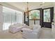 Bright living room featuring a chandelier, white sofas and large windows with bright natural light at 3429 Regal Crest Dr, Longwood, FL 32779