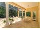 Covered patio featuring tile flooring, outdoor seating, and views of the landscaped backyard at 3429 Regal Crest Dr, Longwood, FL 32779