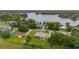 Aerial view of a home with verdant landscaping, near a tranquil lake and neighborhood at 3779 N Econlockhatchee Trl, Orlando, FL 32817