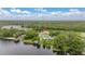 Aerial view of the home, situated on a lake surrounded by lush greenery and mature trees at 3779 N Econlockhatchee Trl, Orlando, FL 32817