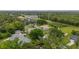 Aerial view of a home featuring a well-maintained lawn and mature trees in a residential neighborhood at 3779 N Econlockhatchee Trl, Orlando, FL 32817
