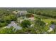 Aerial view of a home featuring a well-maintained lawn and mature trees in a residential neighborhood at 3779 N Econlockhatchee Trl, Orlando, FL 32817