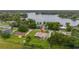 Aerial view of a home with verdant landscaping, near a tranquil lake and neighborhood at 3779 N Econlockhatchee Trl, Orlando, FL 32817