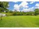 Grassy, flat backyard features mature trees and partial fencing at 3779 N Econlockhatchee Trl, Orlando, FL 32817