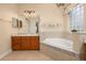Spa-like bathroom featuring a soaking tub with tile surround and elegant fixtures at 3779 N Econlockhatchee Trl, Orlando, FL 32817