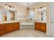 Spacious bathroom with dual sinks, soaking tub, and tile flooring at 3779 N Econlockhatchee Trl, Orlando, FL 32817