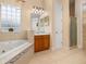 Luxurious bathroom with jetted tub, tiled floor and shower, and natural light at 3779 N Econlockhatchee Trl, Orlando, FL 32817