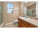 Bathroom with vanity, mirror, toilet, and tub with tiled walls and a glass door at 3779 N Econlockhatchee Trl, Orlando, FL 32817