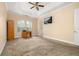 Bright bedroom with neutral colors, carpeting, fan, closet, and natural light at 3779 N Econlockhatchee Trl, Orlando, FL 32817
