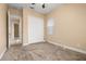 Cozy bedroom with plush carpeting, closet, and a window offering natural light at 3779 N Econlockhatchee Trl, Orlando, FL 32817