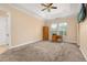 Spacious bedroom features neutral carpeting, tray ceiling, ceiling fan, and plenty of natural light at 3779 N Econlockhatchee Trl, Orlando, FL 32817