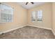 Bright bedroom with neutral carpet, ceiling fan, and large windows offering plenty of natural light at 3779 N Econlockhatchee Trl, Orlando, FL 32817