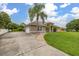 Spacious single-story home with lush lawn, long driveway, and attached two-car garage at 3779 N Econlockhatchee Trl, Orlando, FL 32817
