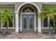 Elegant front entrance with double doors, brick pathway, and well-maintained landscaping at 3779 N Econlockhatchee Trl, Orlando, FL 32817