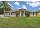 Charming single-story home with well-manicured lawn and elegant architectural details at 3779 N Econlockhatchee Trl, Orlando, FL 32817