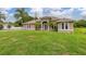 Attractive single-story home featuring a lush green lawn and elegant architectural details at 3779 N Econlockhatchee Trl, Orlando, FL 32817