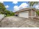 Spacious two-car garage with long driveway and attractive exterior and professional landscaping at 3779 N Econlockhatchee Trl, Orlando, FL 32817
