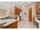 Well-equipped kitchen featuring wood cabinets, a spacious countertop, and tile flooring at 3779 N Econlockhatchee Trl, Orlando, FL 32817