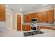Well-lit kitchen featuring wood cabinets, countertop, stainless sink, and modern appliances at 3779 N Econlockhatchee Trl, Orlando, FL 32817