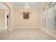 Empty living room featuring neutral walls, tiled floors, and natural light from the windows at 3779 N Econlockhatchee Trl, Orlando, FL 32817