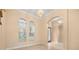 Living room with tiled floors, large windows, and open arched doorways at 3779 N Econlockhatchee Trl, Orlando, FL 32817