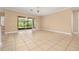 Bright living room with tile floors and a large sliding glass door leading to the lanai at 3779 N Econlockhatchee Trl, Orlando, FL 32817