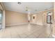Expansive living room featuring neutral tones, tile floors, and multiple entry points for easy flow at 3779 N Econlockhatchee Trl, Orlando, FL 32817