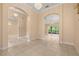 Spacious living room featuring tiled floors, arched doorways, and elegant light fixtures at 3779 N Econlockhatchee Trl, Orlando, FL 32817
