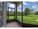 This screened-in patio features tile floors and a relaxing view of the grassy backyard and mature landscaping at 3779 N Econlockhatchee Trl, Orlando, FL 32817