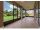 Screened in patio with tile floors and ceiling fans, overlooking well-manicured yard with plenty of space at 3779 N Econlockhatchee Trl, Orlando, FL 32817