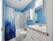 Bathroom featuring a shower/tub combo with bright blue walls and a white vanity at 395 Alcazar Ave, De Leon Springs, FL 32130