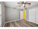 Spacious bedroom featuring laminate floors, a ceiling fan and a closet for storage at 395 Alcazar Ave, De Leon Springs, FL 32130