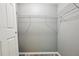 Walk-in closet featuring ample metal shelving for organization and laminate floors at 395 Alcazar Ave, De Leon Springs, FL 32130