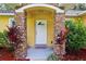 Inviting front entry with stone accents and colorful landscaping at 395 Alcazar Ave, De Leon Springs, FL 32130