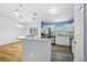 Open concept kitchen featuring stainless steel appliances, white cabinets, and a peninsula island at 395 Alcazar Ave, De Leon Springs, FL 32130