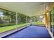 Enclosed lanai has views of the backyard and green foliage at 395 Alcazar Ave, De Leon Springs, FL 32130