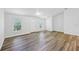 An open-concept living room with lots of natural light from two windows at 395 Alcazar Ave, De Leon Springs, FL 32130