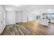 Spacious living room featuring wood flooring and an open layout with a dining area and kitchen at 395 Alcazar Ave, De Leon Springs, FL 32130