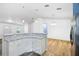 Open living area featuring wood floors, modern lighting, and a kitchen bar at 395 Alcazar Ave, De Leon Springs, FL 32130