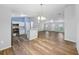 Open-concept living space with wood flooring, a breakfast bar, and an eat in kitchen at 395 Alcazar Ave, De Leon Springs, FL 32130