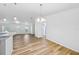 Bright living room features hardwood floors and modern light fixtures at 395 Alcazar Ave, De Leon Springs, FL 32130